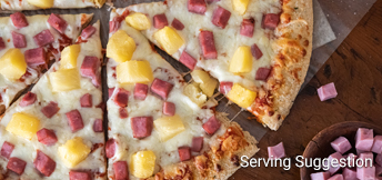 close up of pizza topped with canadian bacon and pineapple