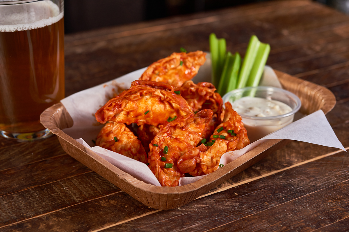 fried dumplings in buffalo sauce