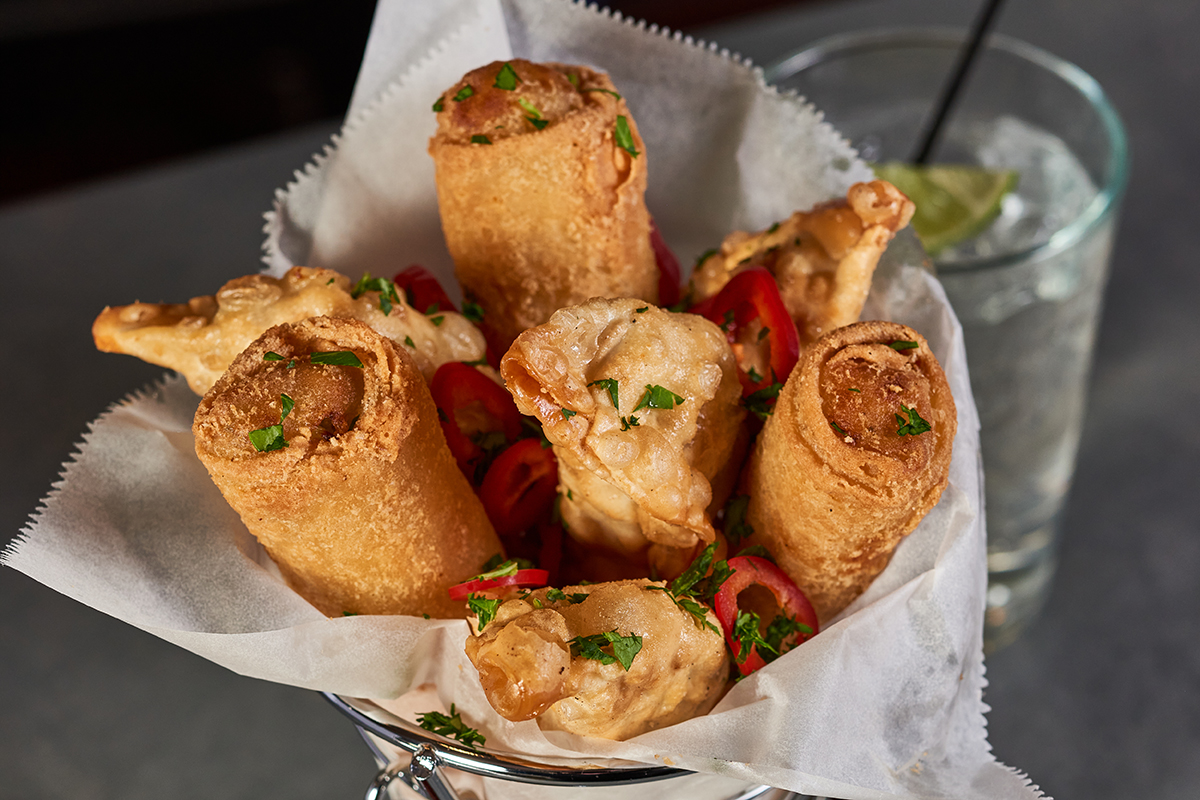 appetizer cup filled with egg rolls and dumplings